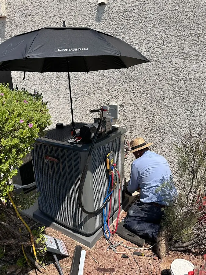 HVAC technician performing outdoor AC maintenance in New Bern