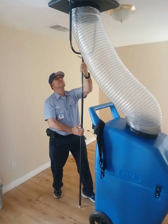 Furnace Tune-Up technician using HEPA equipment in New Bern